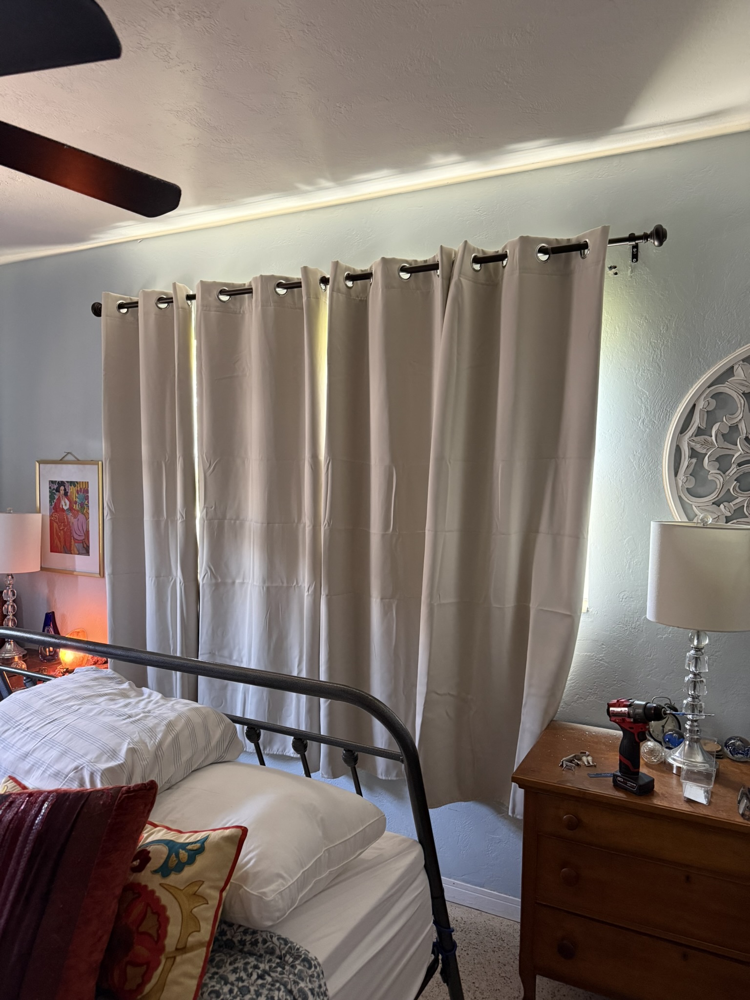 Blackout curtains and rod installed in bedroom