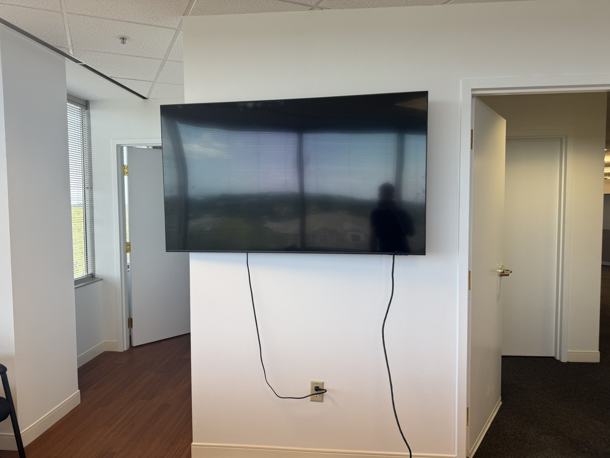 Office TV mounted with clean cable management