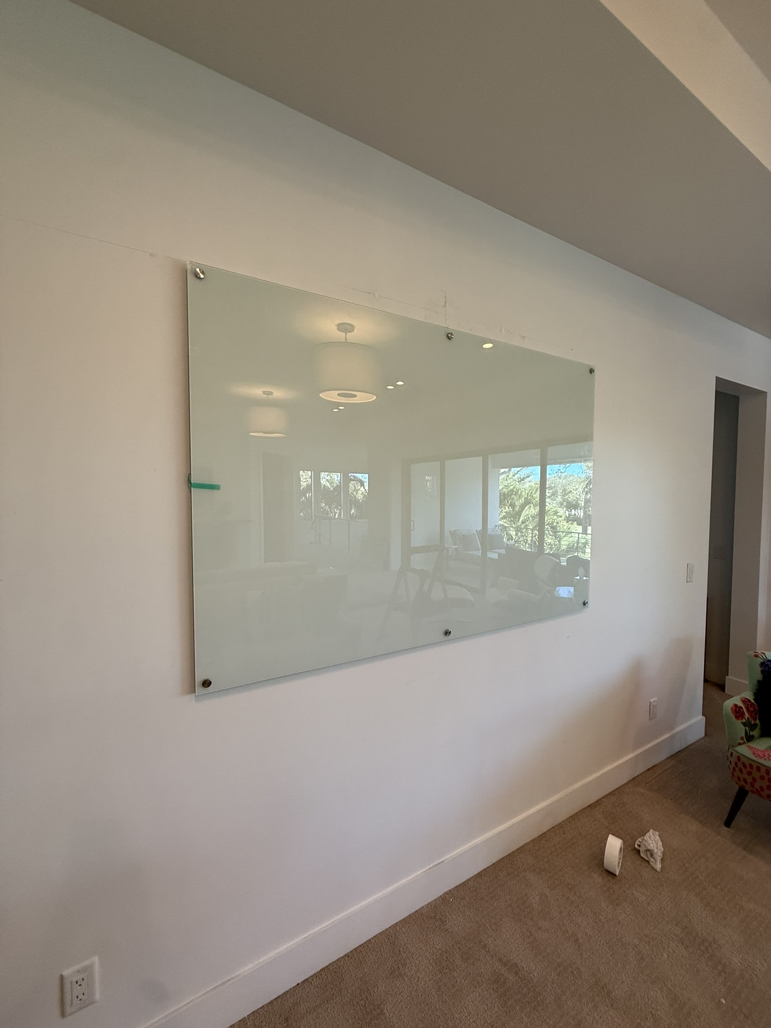 Glass dry-erase board mounted on wall